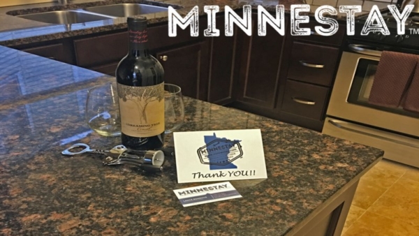 Wine bottle and Minnestay card on kitchen counter.