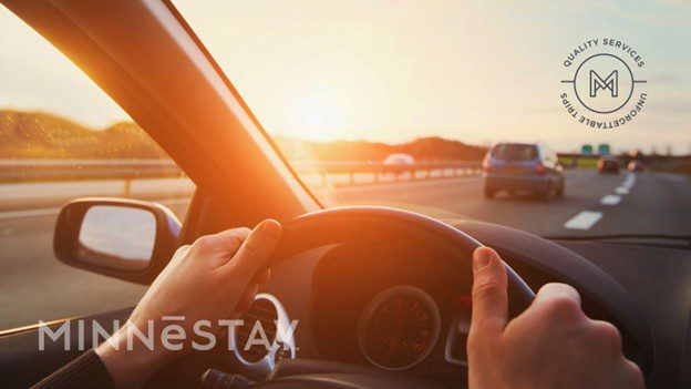 Person driving on a highway on a road trip from Chicago to Minneapolis