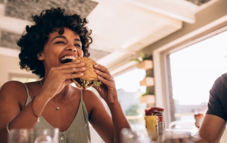 Woman Eating Burger at Hip Restaurant