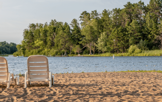 Minnesota beach with two beach chairs facing the water.