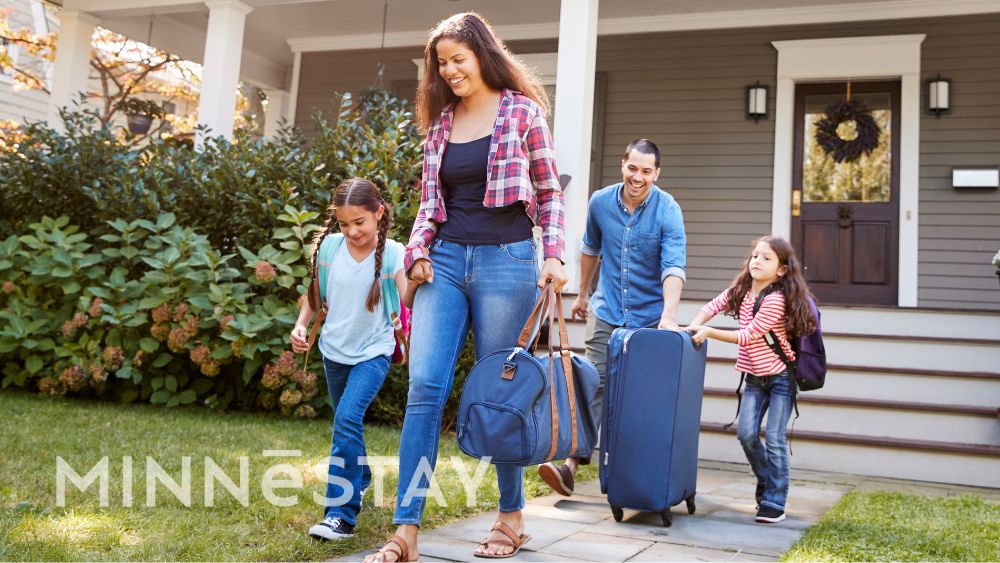 A family who stayed at a historic property with MINNeSTAY leaving their vacation rental to go home