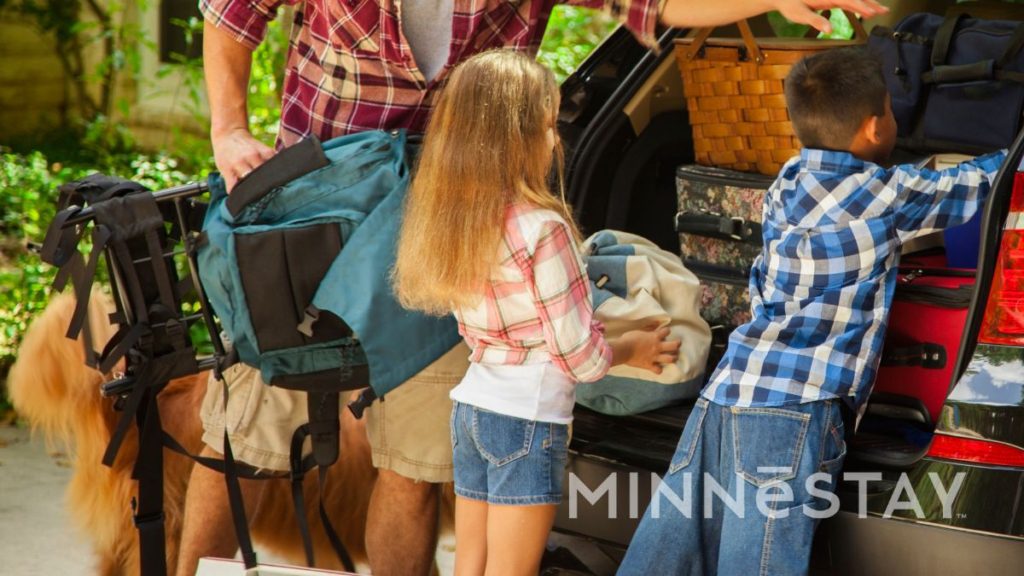 family packing a car getting ready to travel to their MINNeSTAY vacation rental