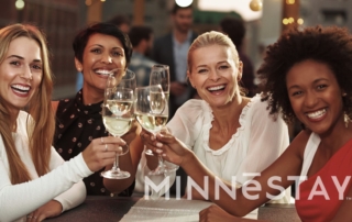 Group of women toasting on an outdoor patio in the Minneapolis area.